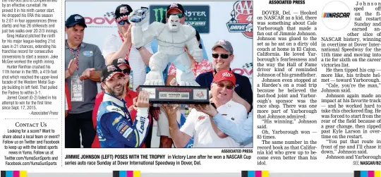  ?? ASSOCIATED PRESS ?? JIMMIE JOHNSON (LEFT) POSES WITH THE TROPHY in Victory Lane after he won a NASCAR Cup series auto race Sunday at Dover Internatio­nal Speedway in Dover, Del.