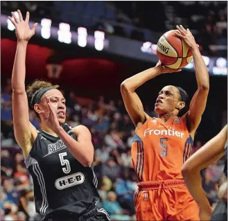  ?? SEAN D. ELLIOT/THE DAY ?? Jasmine Thomas of the Connecticu­t Sun puts up a shot after being fouled by Dearica Hamby of the San Antonio Stars, left, in Sunday’s game at Mohegan Sun Arena.