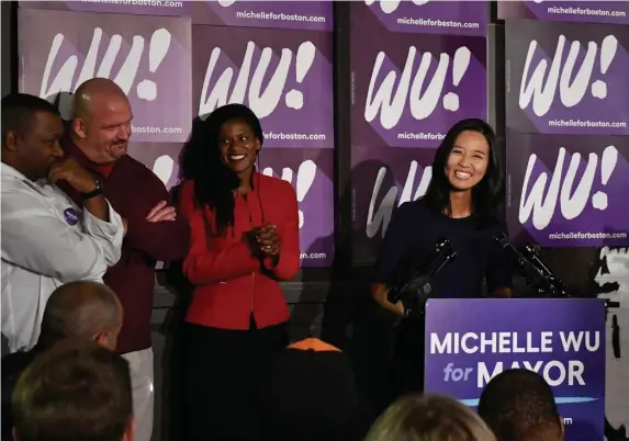  ?? CHrIs CHrIsto / Herald staFF ?? Michelle Wu talks to supporters at the Distractio­n Brewing Company in Roslindale on Tuesday night.