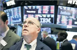  ??  ?? Waiting game: A trader watches nervously at the stock exchange Tuesday.