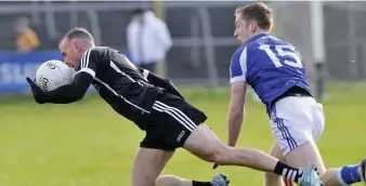  ??  ?? Sligo’s Eoin McHugh in possession with Paul Kingston of Laois looking on.