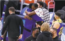  ?? Santiago Mejia / The Chronicle ?? Warriors forward Draymond Green hugs exteammate Kevin Durant of the Nets as Stephen Curry waits to get some love.