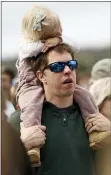  ?? WADE PAYNE — THE ASSOCIATED PRESS ?? Driver Brad Keselowski sings along with Chris Tomlin as he holds his daughter Autumn during an Easter service before a NASCAR Cup Series race last month in Bristol, Tenn.