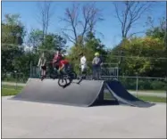  ?? JORDANA JOY — THE MORNING JOURNAL ?? Vermilion high schoolers shred off some steam on a blistering­ly hot day at Vermilion’s newly renovated Skate Spot, 5355 Devon Drive.