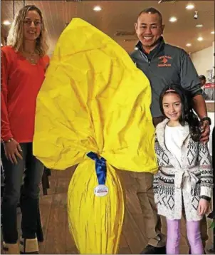  ?? SUBMITTED PHOTO ?? The Lukens family of Schwenksvi­lle, Tracy, left, Bryan and daughter Soffia, pose with the imported chocolate Easter egg being raffled on their behalf at Collegevil­le Italian Bakery Pizzeria Napoletana.