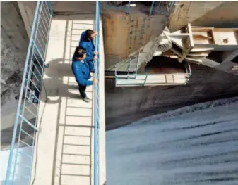  ??  ?? June 5, 2018: Workers check water discharge conditions at Longshou Hydroelect­ric Station in the Qilian Mountains National Nature Reserve. The hydroelect­ric station adopts a self-controlled sluice module to ensure natural water discharge to the lower reaches of the river. by Fan Peishen/xinhua