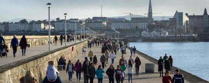  ??  ?? WALKING ON DUN LAOGHAIRE PIER: There has been a sharp drop in belt tightening in the last five years — and it has been driven by younger people and by Dubliners