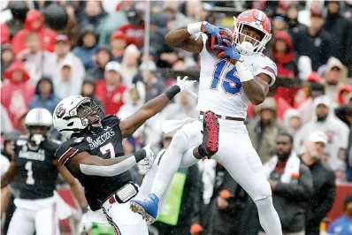  ?? AP Photo/Mic Smith ?? ■ Florida's Jacob Copeland (15) catches a pass for a touchdown as South Carolina’s Jammie Robinson (7) defends in the first half of an NCAA college football game Saturday in Columbia, SC.