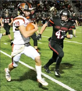  ?? TIMES photograph by Annette Beard ?? Seniors Lance Nunley (No. 41) and Gavin Warden (No. 26) led the defensive tackling with five stops each. Senior Mazon Harris (No. 32) had two stops Friday, Oct. 11.