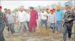  ?? PTI ?? Cabinet minister Navjot Singh Sidhu taking stock of crop damage due to fire in Rajasansi segment of Amritsar.