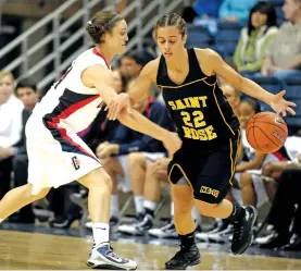  ?? JESSICA HILL/ASSOCIATED PRESS FILE PHOTO ?? Connecticu­t’s Kelly Faris, left, knocks the ball away from Saint Rose’s Adrianna Gaeta during a 2009 game in Storrs, Conn. The Saint Rose Golden Knights will play in the Division II women’s tournament for the first time in 13 years and the final time, as the small Catholic private school in New York is closing later this year.