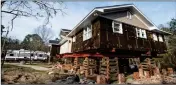  ?? ASSOCIATED PRESS ?? A TRAVEL CAMPER sits in the driveway outside of a home in the process of being raised after being damaged by floodwater­s from Hurricane Florence Friday, Feb. 1, in Conway, S.C.