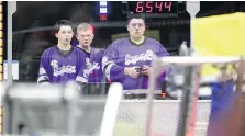  ??  ?? The intense looks on the faces of Adam Tronchin, left, Ethan Richard and Justin de Bont of 6544 A-Team reflect the level of competitio­n at the fifth annual Windsor Essex Great Lakes District FIRST Robotics competitio­n.