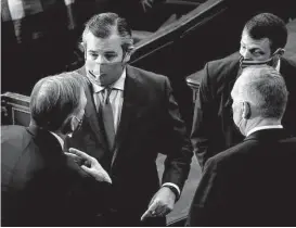  ?? Getty Images ?? Sen. Ted Cruz, R-Texas, talks with members during a joint session of Congress to certify the 2020 Electoral College results on Jan. 6, 2021.