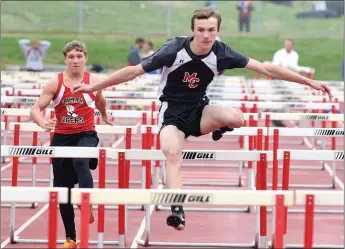  ?? RICK PECK/SPECIAL TO MCDONALD COUNTY PRESS ?? McDonald County’s Joel King clears a hurdle on his way to a second place finish in the 110 hurdles at the 9/10 Mustang Stampede held April 2 at MCHS.