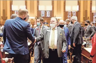  ?? Georgia house media ?? Sen. Jeff Mullis, R-Chickamaug­a, greets a state representa­tive on his way into the House chamber for Gov. Brian Kemp’s annual address to the Legislatur­e. Mullis retired in 2022 after 22 years in office.