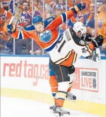  ??  ?? OILERS DEFENSEMAN Griffin Reinhart and Ducks right wing Chris Wagner collide in balletic fashion during Game 6.