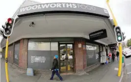  ?? — Reuters ?? A woman walks past an outlet of retailer Woolworths in Cape Town.