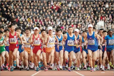  ?? EDJONES/AFP ?? Competitor­s cross the start line of the the annual Pyongyang marathon at Kim Il-sung Stadium in Pyongyang on Sunday.