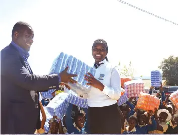  ??  ?? It was all smiles as Cde Supa Mandiwanzi­ra hands over sanitary wear to Nyangani and Crossdale high schools female pupils recently