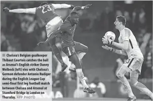  ?? AFP PHOTO ?? Chelsea’s Belgian goalkeeper Thibaut Courtois catches the ball as Arsenal’s English striker Danny Welbeck (left) vies with Chelsea’s German defender Antonio Rudiger during the English League Cup semi-final first leg football match between Chelsea and...