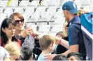  ??  ?? Centre of attention: Ben Stokes signs autographs for England fans yesterday