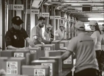  ??  ?? TEXAS AREA RESIDENTS CASH IN: Pictured above and watched closely by guards are protected U.S. Coin Packages containing the valuable unsearched Vault Bags that everyone will be trying to get. It’s hard to tell how much these unsearched bags loaded with rarely seen U.S. Gov’t issued coins could be worth someday. That’s because each Vault Bag is known to contain nearly 3 pounds of U.S. Gov’t issued coins some dating back to the early 1800’s, so you better believe at just $980 these Unsearched Vault Bags are a real steal.