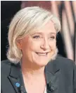  ??  ?? POLITICAL FOOTBALL: Emmanuel Macron and Marine Le Pen have traded blows over the controvers­ial swimsuit for Muslim women.