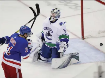  ?? The Associated Press ?? New York Rangers forward Brett Howden (21) raises his arms in celebratio­n of scoring on Vancouver Canucks goaltender Jacob Markstrom during third-period NHL action on Monday night in NewYork.The Canucks lost 2-1.