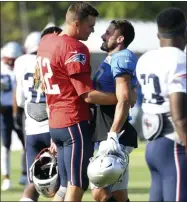  ?? DANIEL MEARS - THE ASSOCIATED PRESS ?? New England Patriots quarterbac­k Tom Brady, left, hugs former teammate Detroit Lions wide receiver Danny Amendola as they make their way onto the field for a combined NFL football practice in Allen Park, Mich., Monday, Aug. 5, 2019.