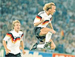  ?? ?? Brehme celebrates his World Cup-winning penalty with his teammate Jürgen Klinsmann in pursuit