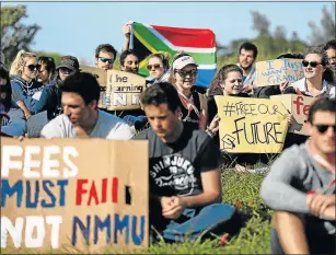  ?? Picture: FILE ?? FREE EDUCATION DEMAND: In this file picture from this time last year, about 80 students demanding the reopening of Nelson Mandela University gather near the campus in Port Elizabeth for a silent protest while, a few metres away, #FeesMustFa­ll activists...