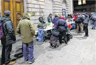  ?? PHOTO: PA ?? Shocking: Families queue up at The Lending Hand, a soup kitchen feeding up to 300 people every Monday on College Green in Dublin.