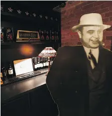  ??  ?? A cutout of notorious gangster Al Capone is on display in the speakeasy area of the Canadian Club Brand Centre. During the prohibitio­n era, Capone was one of Hiram Walker’s biggest customers.