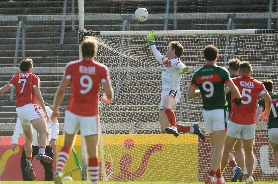  ??  ?? David Clarke of Mayo tips a goalbound effort from Cork’s Tomás Clancy over the ball during the All-Ireland Senior Football Championsh­ip Round 4A Qualifier between Cork and Mayo at the Gaelic Grounds in Co. Limerick. Photo by Sportsfile