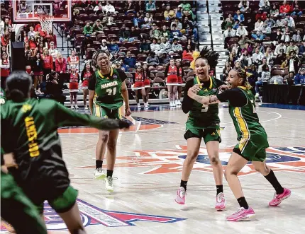  ?? Tyler Sizemore/Hearst Connecticu­t Media ?? Hamden’s Aunee Brookshire (21), Alana Philpotts (5), and Leah Philpotts (15) celebrate after beating Sacred Heart Academy in the Class LL championsh­ip game at Mohegan Sun Arena in Uncasville on Sunday.