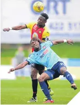  ??  ?? ■ Abdul Osman heads clear under pressure from Rakish Bingham.