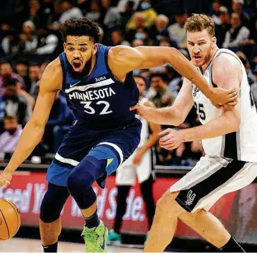  ?? Andy Clayton-king / Associated Press ?? Spurs center Jakob Poeltl, playing in his first game since Nov. 1, finished with two points in 15 minutes of action during Thursday’s loss. His center counterpar­t, Karl-anthony Towns (32), had 25 points and 12 rebounds.