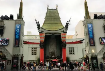  ?? The Associated Press ?? EASTERN INFLUENCE: Tourists gather in the forecourt of the TCL Chinese Theatre on Monday in the Hollywood section of Los Angeles. Older than the Academy Awards and still an industry standout, Hollywood’s storied Chinese Theatre turns 90 this week.