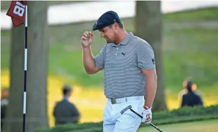  ?? DANIELLE PARHIZKARA­N/USA TODAY SPORTS ?? Bryson Dechambeau tips his cap as he celebrates on the 18th green after winning the U.S. Open at Winged Foot Golf Club. Dechambeau won the event by six strokes.