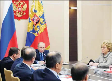  ??  ?? Russian President Vladimir Putin (background), chairs a meeting of the Security Council at the Novo-Ogaryovo residence outside Moscow, Russia on March 31. PremierDmi­try Medvedev sits at left and Federation Council Speaker Valentina Matviyenko at right.