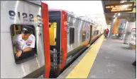  ?? Matthew Brown / Hearst Connecticu­t Media ?? A Metro-North conductor hangs out a window as a train prepares to leave the Stamford train station.