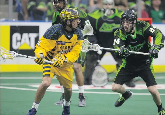  ?? KAYLE NEIS ?? Georgia Swarm’s Lyle Thompson battles Saskatchew­an Rush defender Ryan Dilks in the title game at SaskTel Centre in June. New turf is being added starting this season.