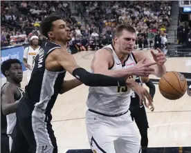  ?? ERIC GAY — THE ASSOCIATED PRESS ?? Spurs center Victor Wembanyama knocks the ball away from Nuggets center Nikola Jokic during the second half on Friday.
