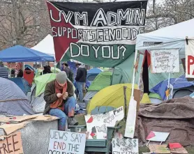  ?? ?? UVM student protesters erected pro-Palestine flags and signs throughout the encampment outside Andrew Harris Commons. APRIL BARTON/FREE PRESS