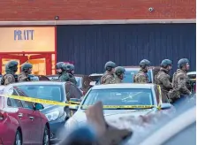  ?? MATT MARTON/ASSOCIATED PRESS ?? Law enforcemen­t officers gather outside the Henry Pratt Co. manufactur­ing plant Friday in Aurora, Ill. Police say a gunman killed several people and injured police officers before he was fatally shot.