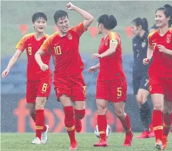  ??  ?? China players celebrate a goal against Thailand in an Olympic qualifier in Sydney.