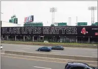  ?? Kathryn Riley / TNS ?? A Black Lives Matter billboard is displayed over the Massachuse­tts Turnpike on Opening Day at Fenway Park in 2020 in Boston.