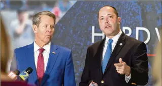  ?? ARVIN TEMKAR/AJC 2023 ?? Georgia AG Chris Carr (right), shown with Gov. Brian Kemp last year, said Wednesday he added the state to a federal suit against President Joe Biden’s new college debt relief program. “Despite the Court having already settled this issue, the Biden administra­tion continues to brazenly violate the law,” Carr said.