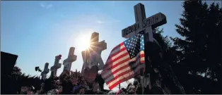  ?? JOSE LUIS MAGANA/THE ASSOCIATED PRESS ?? An American flag and a Star of David adorn crosses representi­ng the journalist­s killed, at a makeshift memorial outside the office building housing The Capital Gazette newspaper in Annapolis, Md., July 1. Jarrod Ramos was charged with murder after...